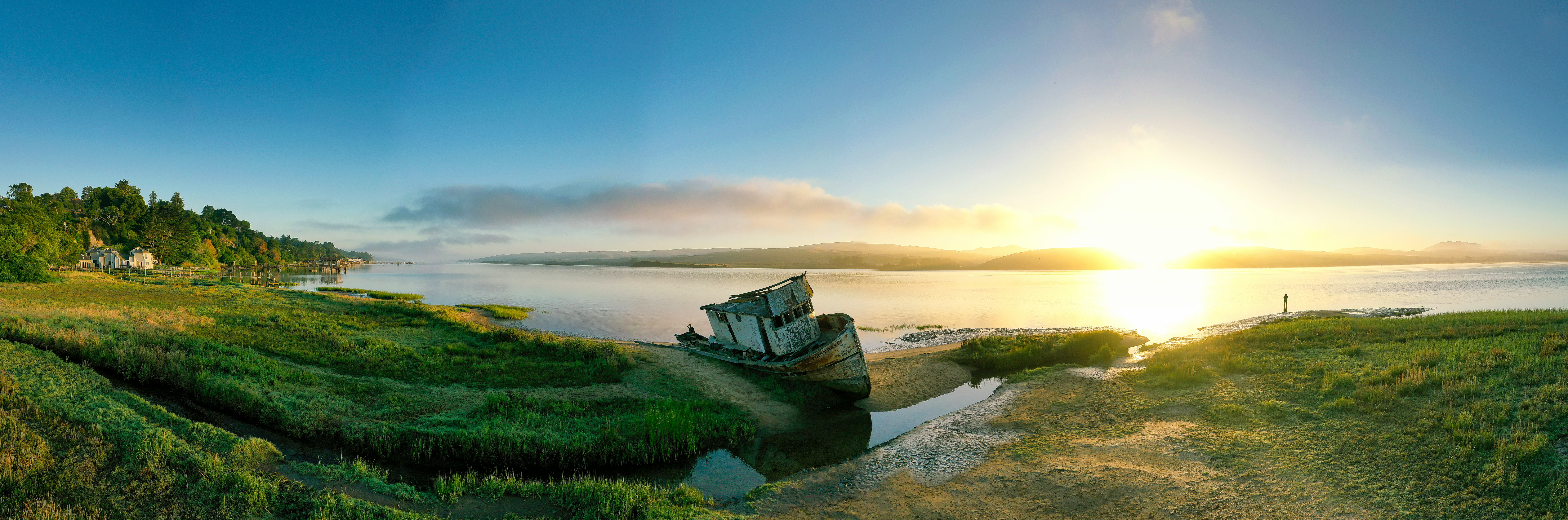 panoramic photography of green field and blue sea